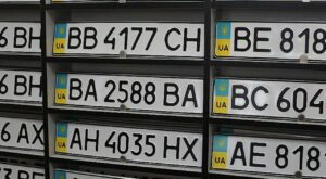 Білий автомобіль із новим номерним знаком на кузові — ілюстрація сучасних правил нумерації в Україні